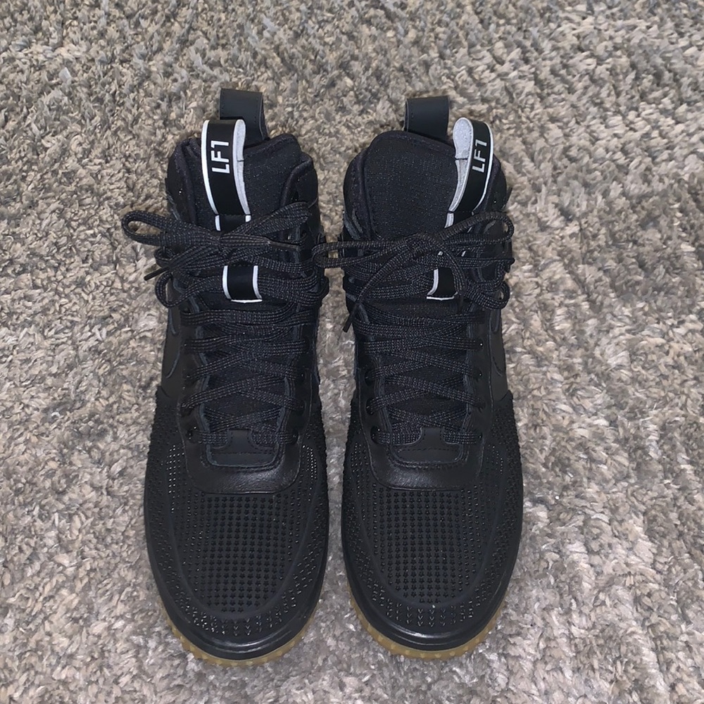 Black high top laced up sneakers